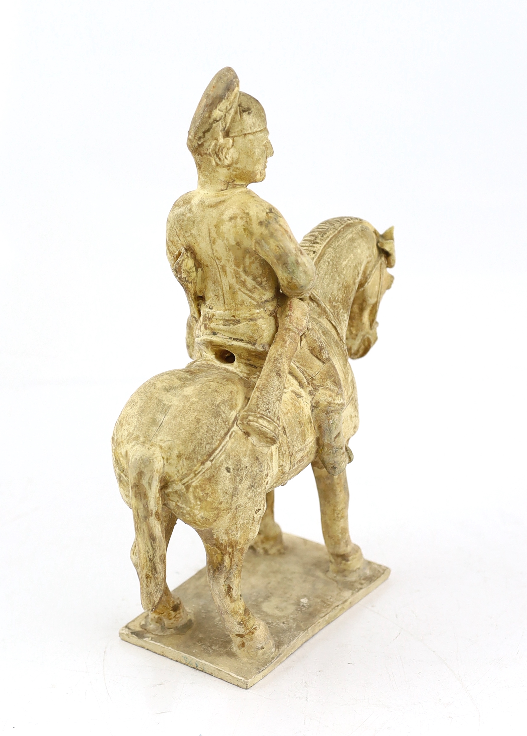 A Chinese cream glazed pottery model of an archer on horseback, Tang Dynasty (618-906 AD)